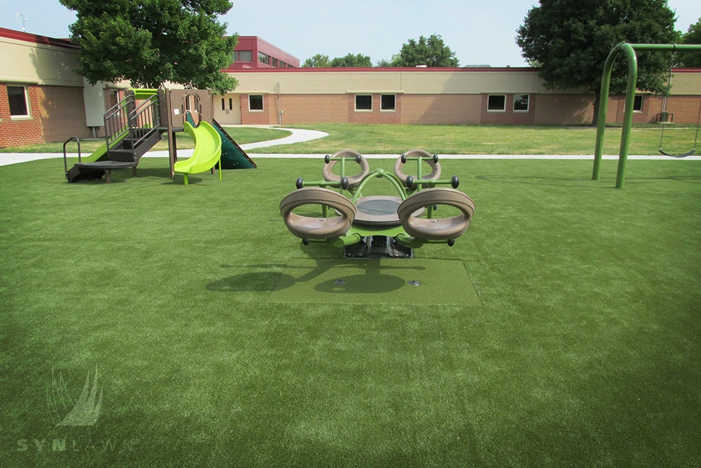image of playground seesaw with synthetic play grass
