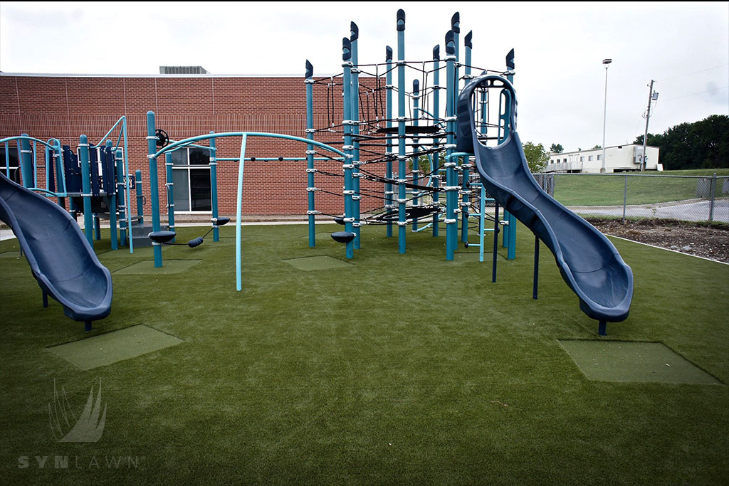 image of navy slides at lee’s summit mo playground with safe artificial grass playground surface