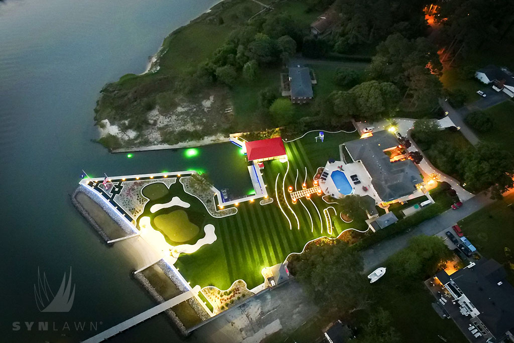 image of a large backyard with a backyard putting green and artificial grass