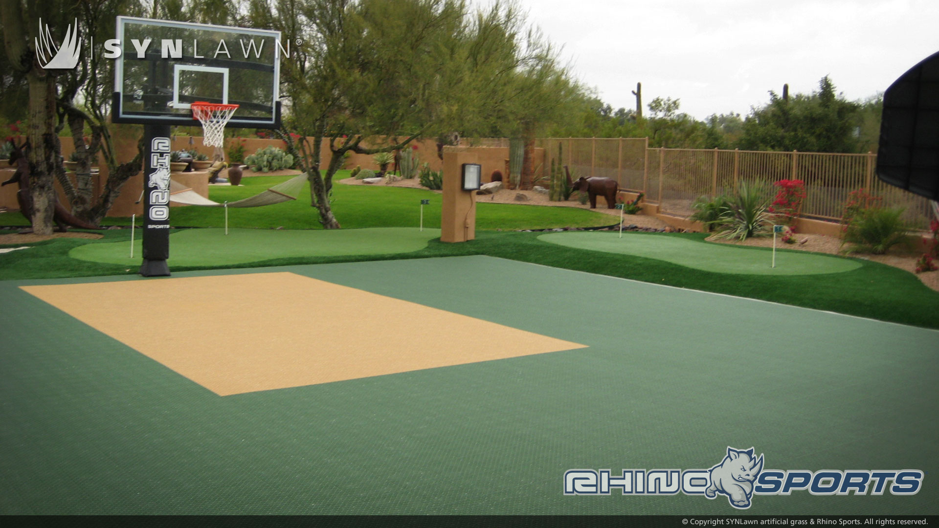 image of a backyard Rhino Sports basketball court with artificial grass putting green