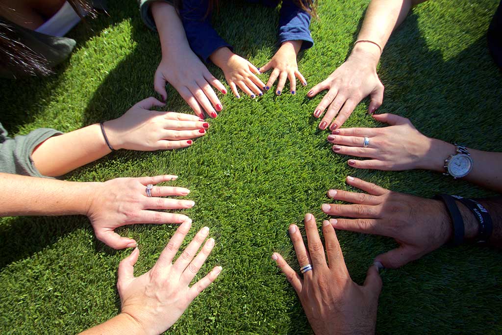 image of synlawn artificial grass with hands