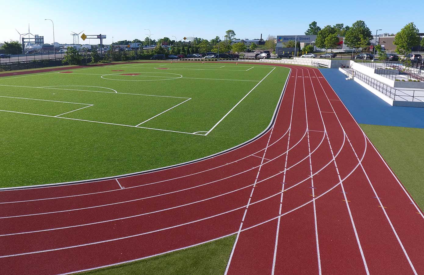 ProductPage_Hero_Agility Aerial view of a track and field with red athletic surfacing