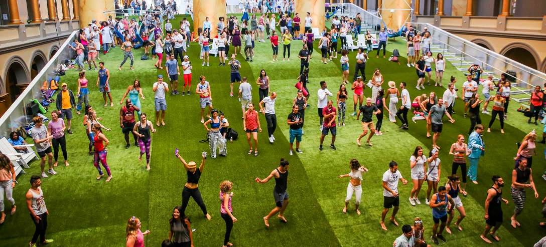 SYNLawn_DCNatlBldgMuseum People doing yoga, dancing, standing on a large artificial turf covering