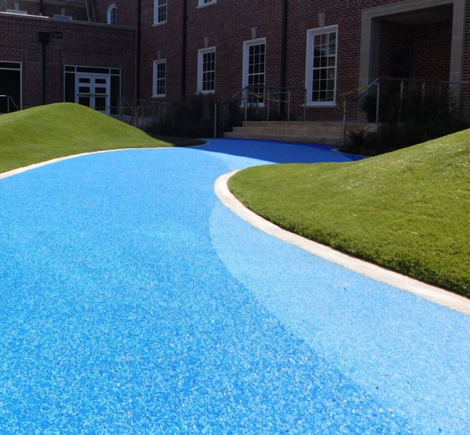 Synpour_100 Blue pour in place path cutting through small hills of artificial grass