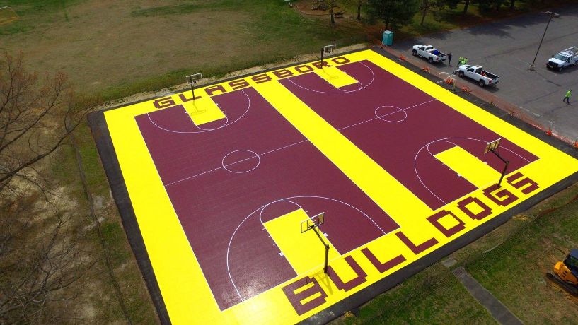 Yellow and red outdoor court with text on both ends