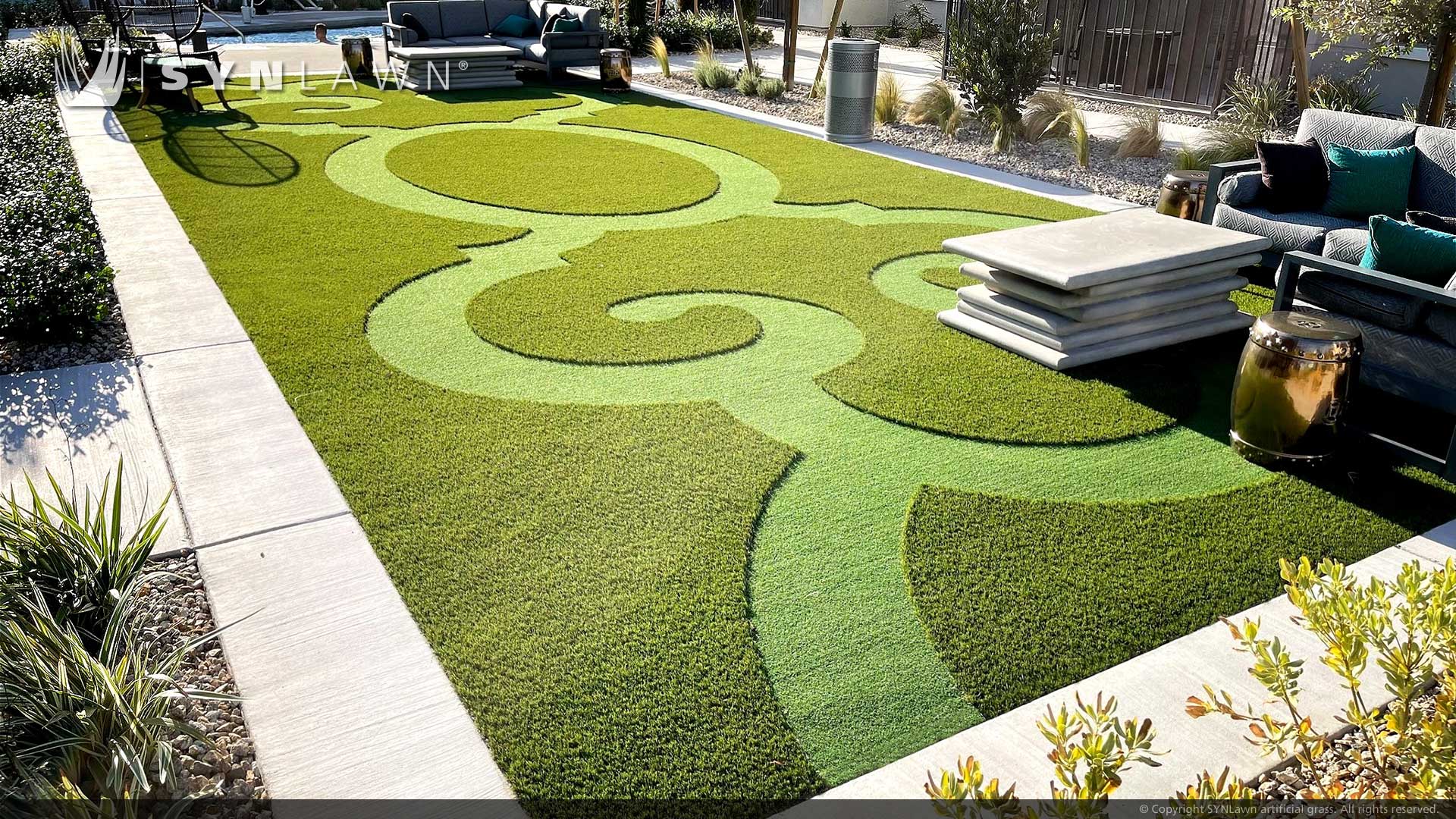 pre-fab-prefab-custom-logo-inlay-to-turf-artificial-grass-the-elysian Custom turf logos on a long lawn